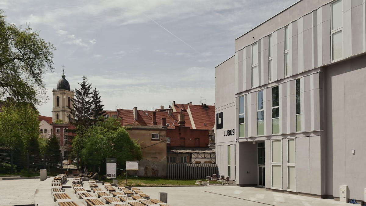 Modern and historic buildings with outdoor benches in Zielona Góra, Poland.